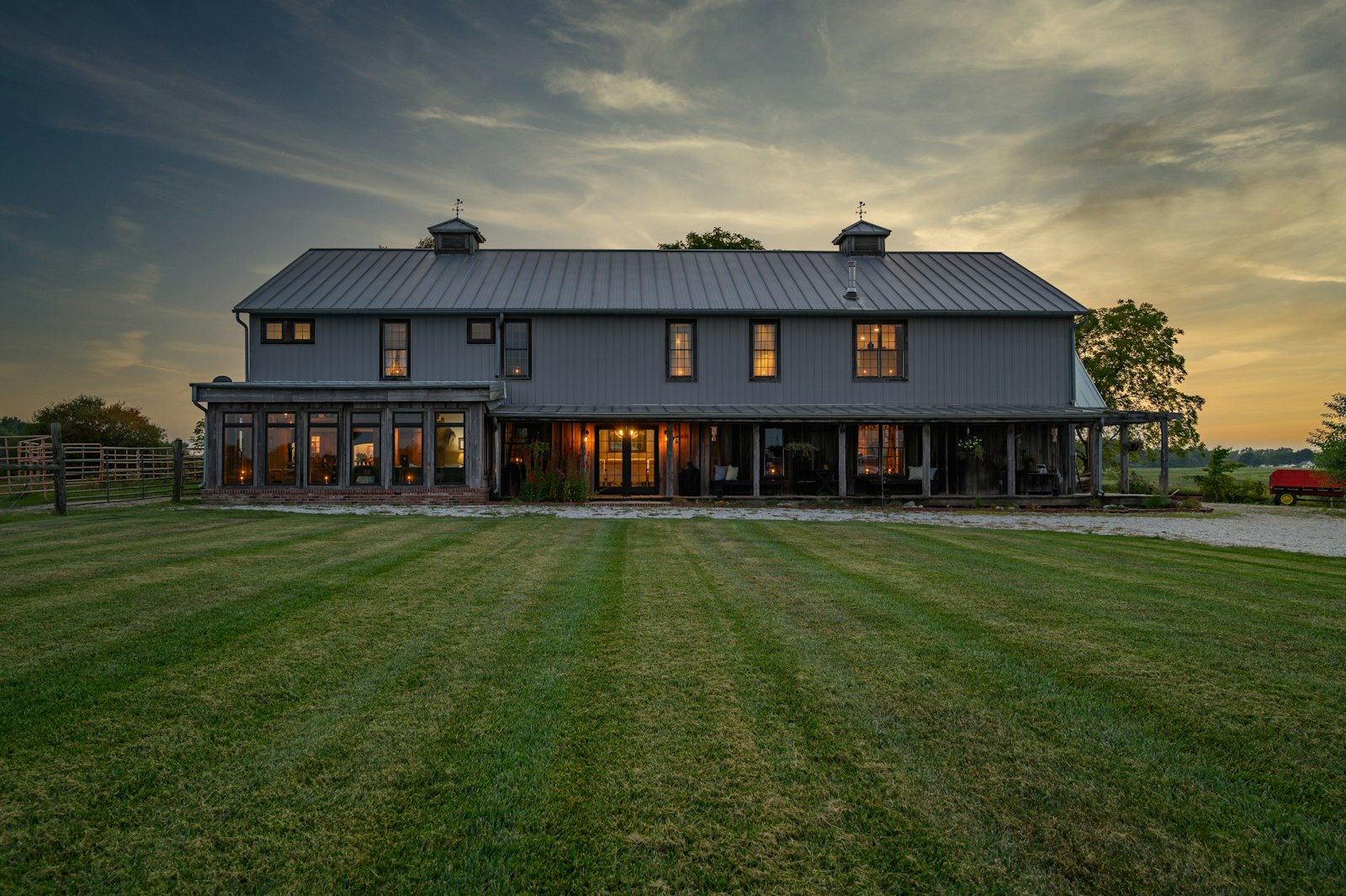 Barn-style wooden home on an open grass property